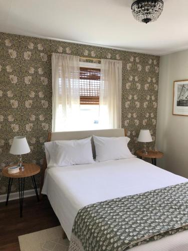 a bedroom with a large bed and a window at Sea Fog Cottage in Camden