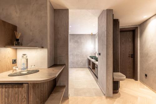 a kitchen with a counter and a sink in a room at Quellenhof Luxury Resort Passeier in San Martino