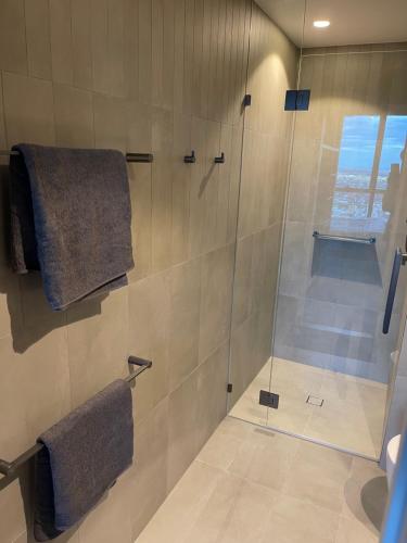 a bathroom with a shower with a glass door at Queen's Wharf - Hosted by Nick in Brisbane