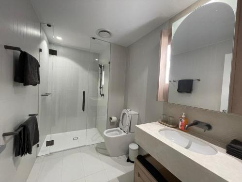 a bathroom with a shower and a toilet and a sink at Queen's Wharf - Hosted by Nick in Brisbane