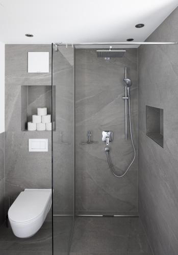 a bathroom with a shower with a toilet and a sink at Ferienwohnung Simlhof in Inzing