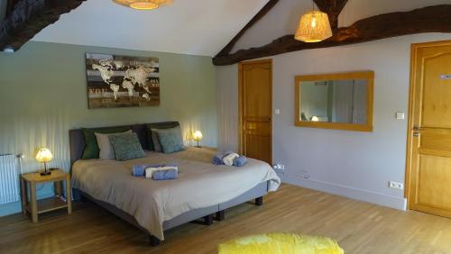 a bedroom with a bed with blue towels on it at Favau in Villeneuve-sur-Lot