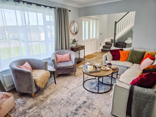 a living room with a couch and chairs and a table at Luxury Sea View Retreat with Hot Tub Sleeps 8 in Dover