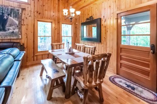 a dining room with a table and chairs at Mountain Getaway with Hot Tub & Game Room cabin in Cleveland
