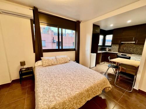a bedroom with a bed and a kitchen with a desk at MT Boutique Suites y Apartamentos - Adults Only - in Mataró