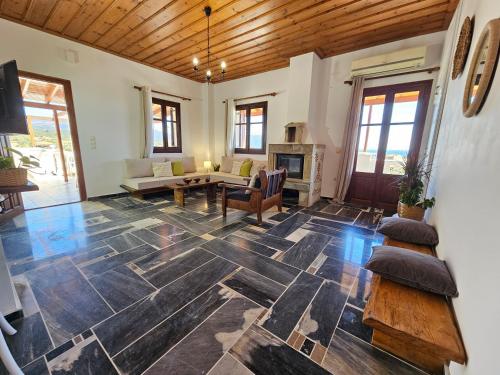 a living room with a table and a fireplace at Lemon Nest 2 in Votsalákia