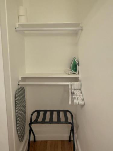 a closet with a shelf and a chair in it at Your Cozy-studiohighfallstvkitchenrochestdt in Rochester