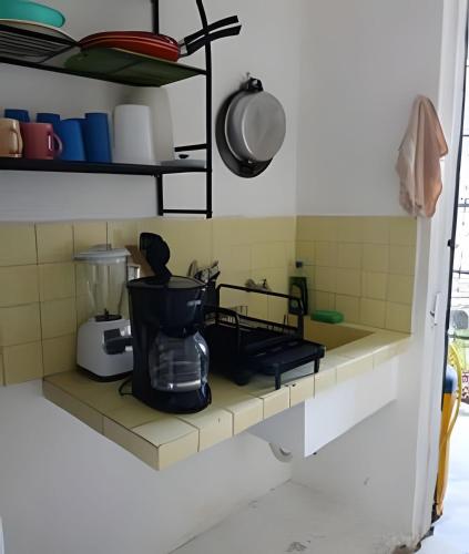 a kitchen counter with a coffee maker on it at Cómodo departamento en el corazón de Cancún in Cancún