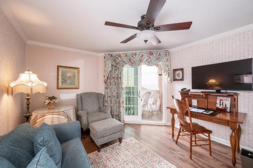 a living room with a blue couch and a table at Boardwalk Plaza Hotel in Rehoboth Beach