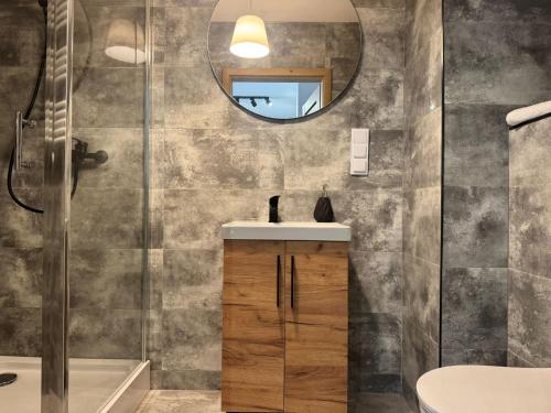 a bathroom with a sink and a mirror at Apartament Bulwary 7 in Oświęcim