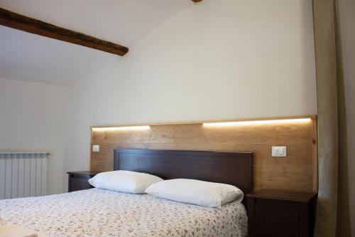 a bedroom with a bed with two pillows on it at Agriturismo Valpagliaro in Formignana