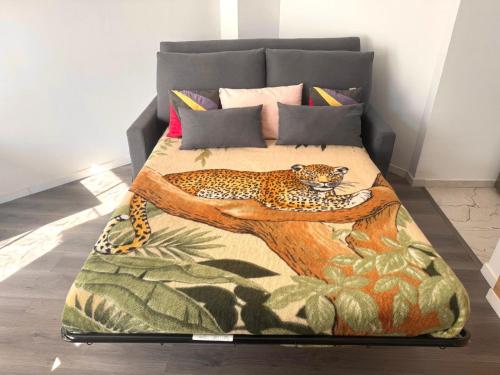 a bed with a leopard sitting on a tree branch at 24 7 Open Apartment Parking 15'Paris 5'Athletica bis in Saint-Gratien