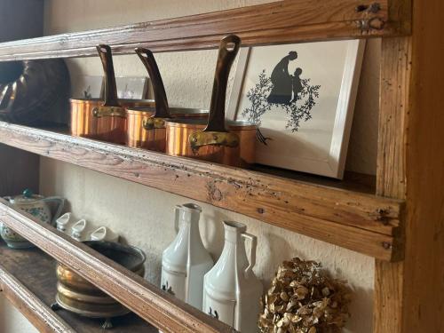 a wooden shelf with vases and a picture of a witch at Finkenhof - Haus Meersmannufer in Hannover