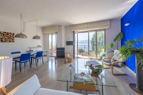 a living room with a glass table and blue walls at Blue Dream in Ispra