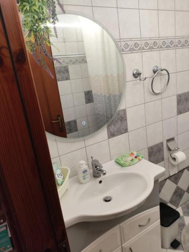 a bathroom with a sink and a mirror at Anna's Garden House in Limenas