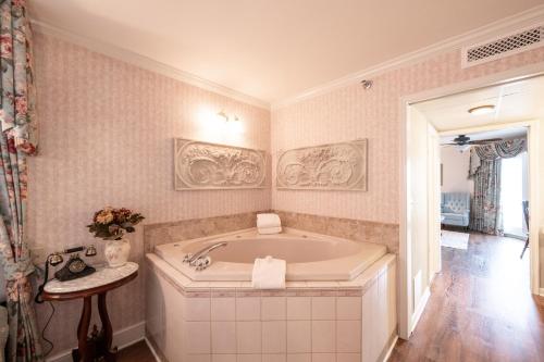 a large bathroom with a tub in a room at Boardwalk Plaza Hotel in Rehoboth Beach