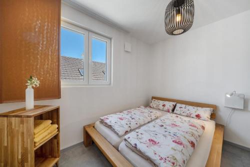 a bedroom with a bed and a window at Katharinenbergblick in Endingen