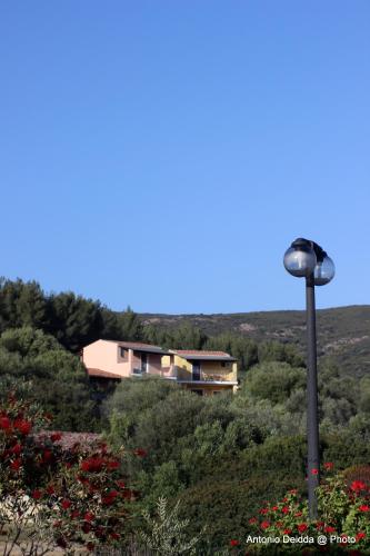 a house on a hill with a light pole at Hotel Belvedere in Teulada