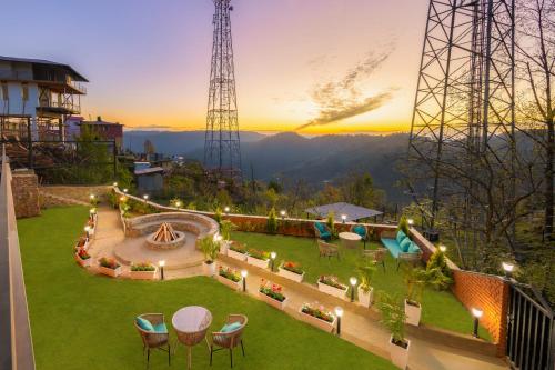 a view of a patio with chairs and a table at Kyomi Retreat-Mukteshwar in Mukteswar