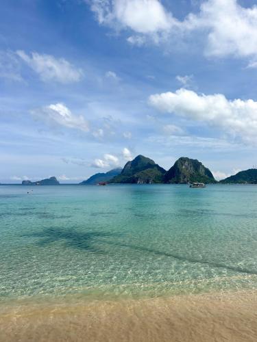 a view of the ocean with mountains in the background at La Casita in El Nido