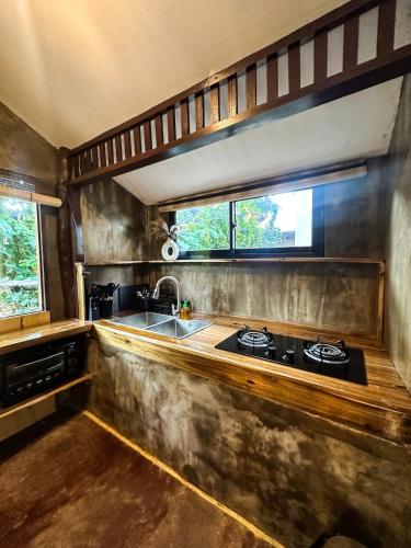 a kitchen with a stove and a sink at La Casita in El Nido