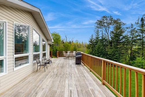 a deck with chairs and a grill on a house at Ski Dreams in Dover