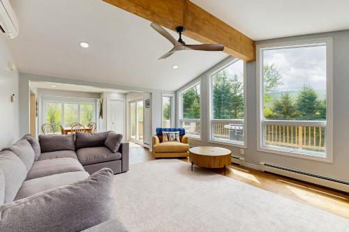 a living room with a couch and a ceiling fan at Ski Dreams in Dover