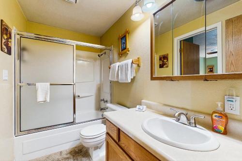 a bathroom with a sink and a shower and a toilet at Aspen Village Golf Course Condo - Snowshoes in McCall