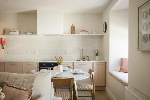 a kitchen with a table and a dining room at The Old Schoolhouse - Castle View in Donegal