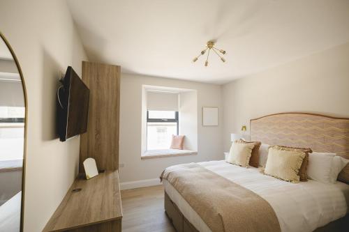 a bedroom with a large bed and a window at The Old Schoolhouse - Castle View in Donegal
