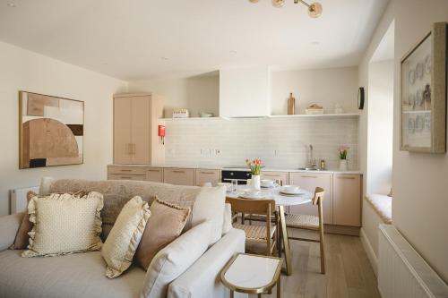 a living room with a couch and a table at The Old Schoolhouse - Castle View in Donegal