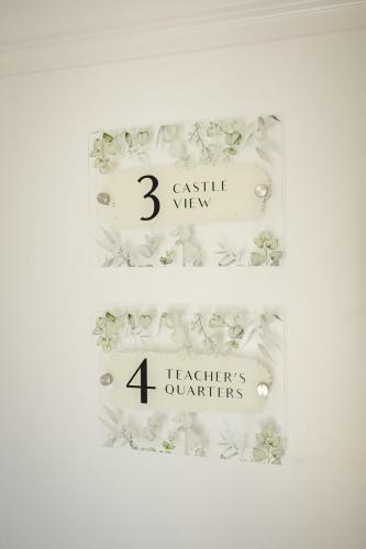 two signs for a display with flowers and buttons at The Old Schoolhouse - Castle View in Donegal