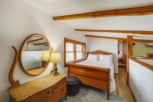 a bedroom with a bed and a mirror at 2 Mi to Appalachian State Cabin with Outdoor Spaces in Boone
