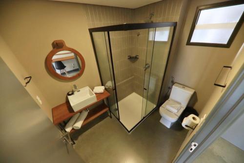 a bathroom with a shower and a sink and a toilet at 9006 Suites Natal Hotel in Natal