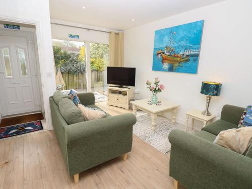 a living room with two couches and a tv at Delaware M3 in Yarmouth