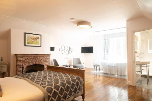 a bedroom with a bed and a fireplace at The Olde Bell, BW Signature Collection in Marlow
