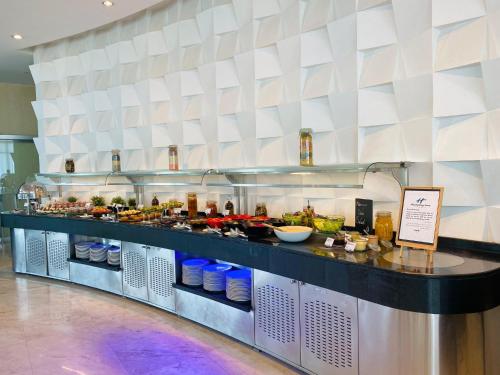 a buffet line in a restaurant with a lot of food at Holiday Inn Abu Dhabi by IHG in Abu Dhabi
