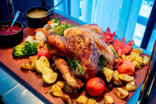a plate of food with a chicken and vegetables at Holiday Inn Abu Dhabi by IHG in Abu Dhabi