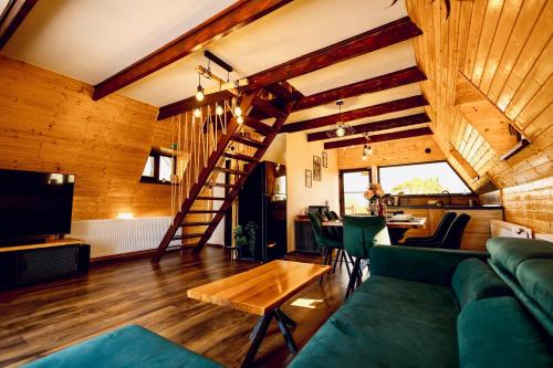 a living room with a green couch and a wooden ceiling at Cabana Galaxy A Frame by Cabanele Galaxy in Cucuteni