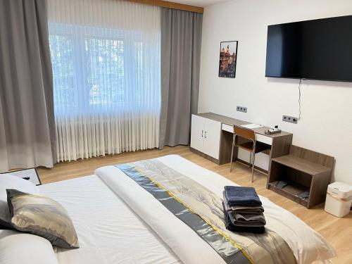 a bedroom with a large bed and a flat screen tv at Ferienhaus große Villa "Smart home" in Euskirchen