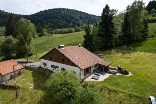an aerial view of a house in a field at La Ferme du Douanier & Spa 5 étoiles ALL INCLUSIVE in Ventron