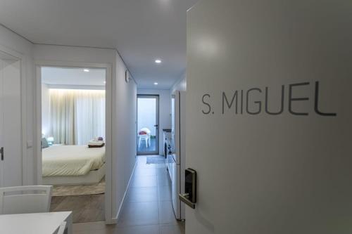 a white room with a bed and a mirror at GuestReady - Passal Guesthouse in Ponta Delgada