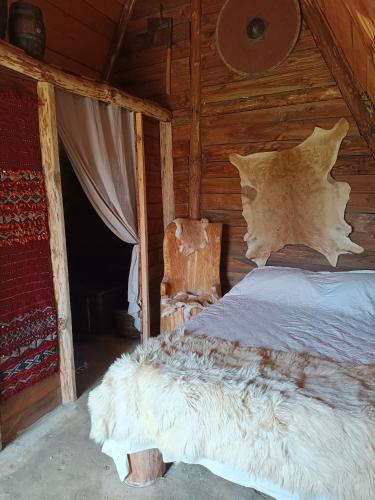 a bed in a wooden room with a chair at les portes de l'histoire in Pleine-Fougères