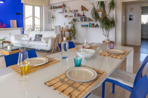 a dining room and living room with a table and chairs at Blue Dream in Ispra