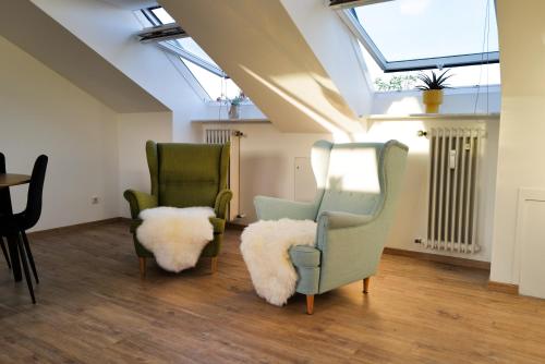 two green chairs with furry cushions in a living room at ThermenNest Erding, parking, wifi in Erding
