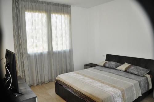a bedroom with a bed and a large window at Oasi Temerano in Seclì