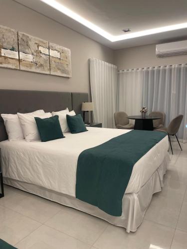a bedroom with a large bed and a table at Hotel Boutique Gualamba in General Pinedo