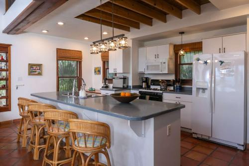 a kitchen with a large island with bar stools at Cielo Vista Villa 3 BDRM Sleeps 6 Heavenly View in Cruz Bay