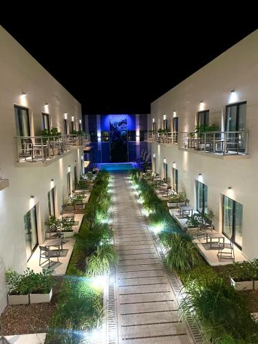 a hallway of a building with tables and chairs at Hotel Boutique Gualamba in General Pinedo