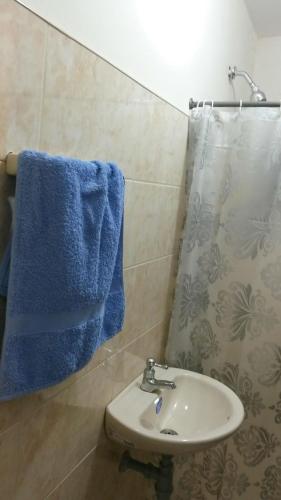 a bathroom with a sink and a blue towel at Selvática Alojamiento Eco in Medellín